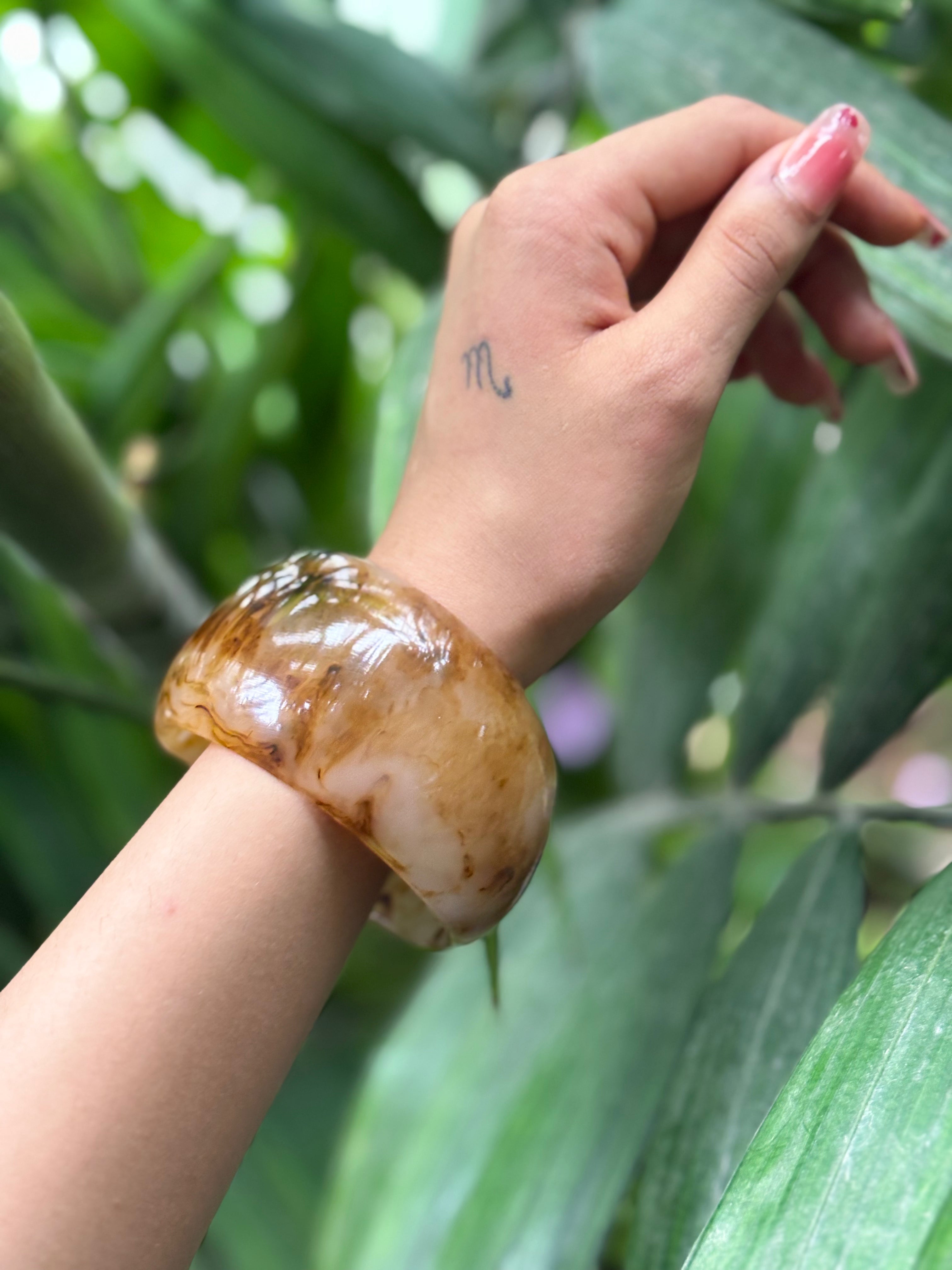 Close-up of caramel swirl resin bangle finish