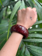 Close-up of red marbled resin bangle texture